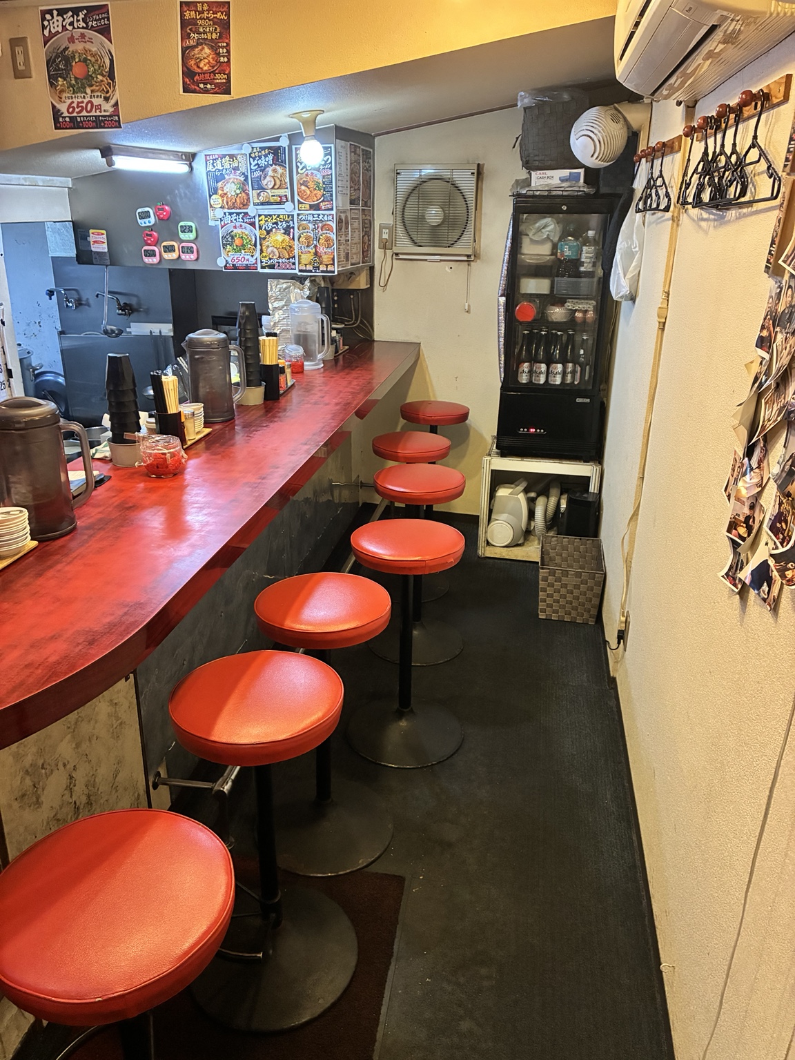赤いカウンターと椅子が並ぶ唯一無二の店内